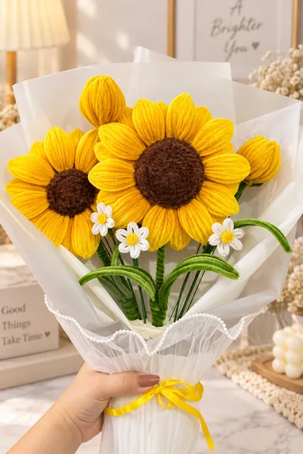 A sunflower and daisy bouquet tied with a yellow ribbon